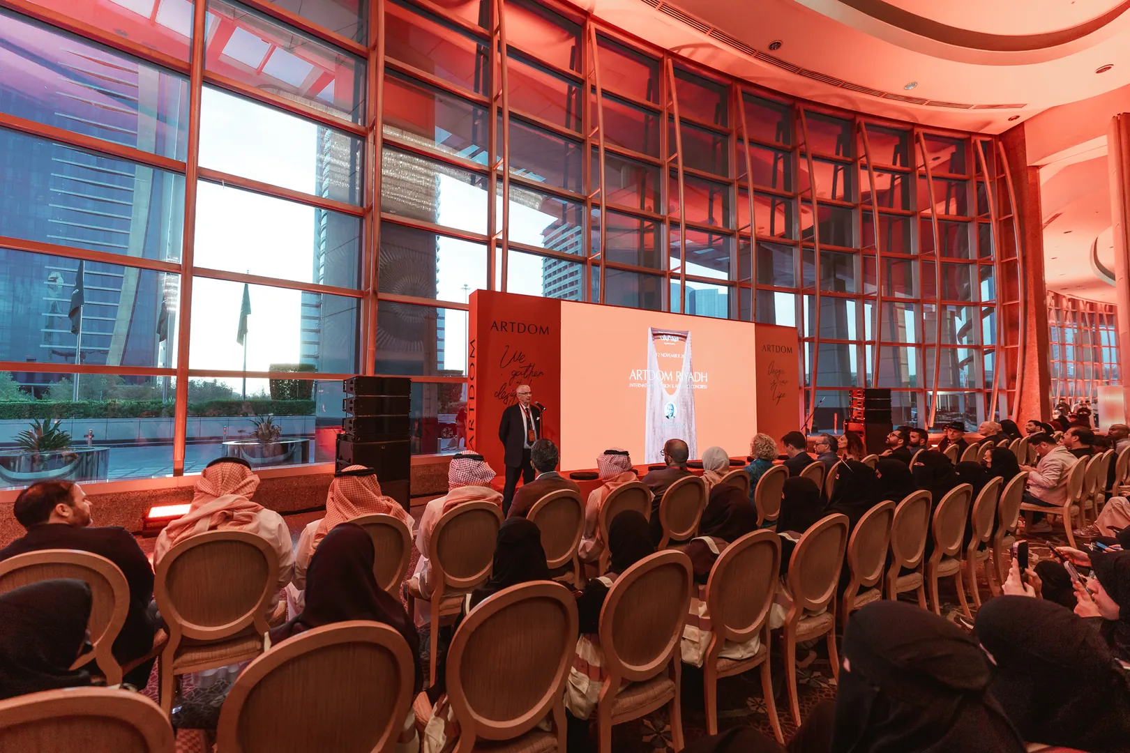 A full hall facing the stage at ARTDOM Riyadh