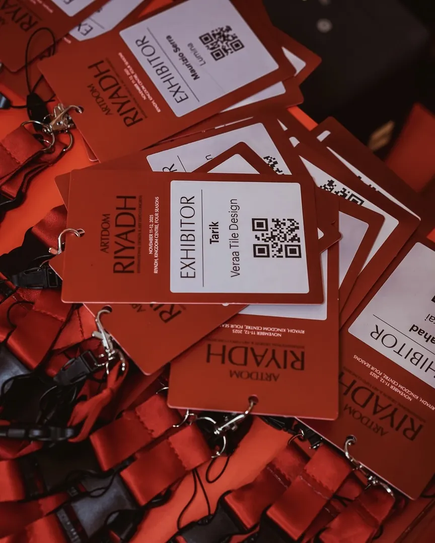 Exhibitor badges on red lanyards