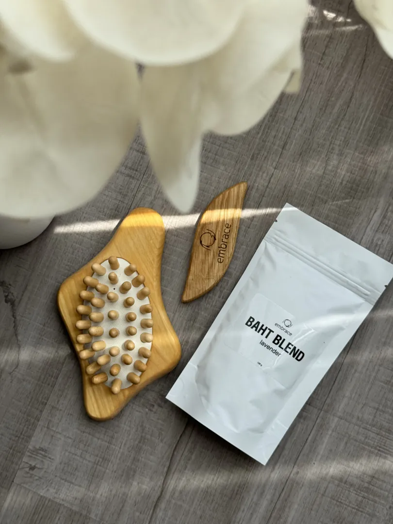 The bath blend pouch and wooden brushes on grey wood