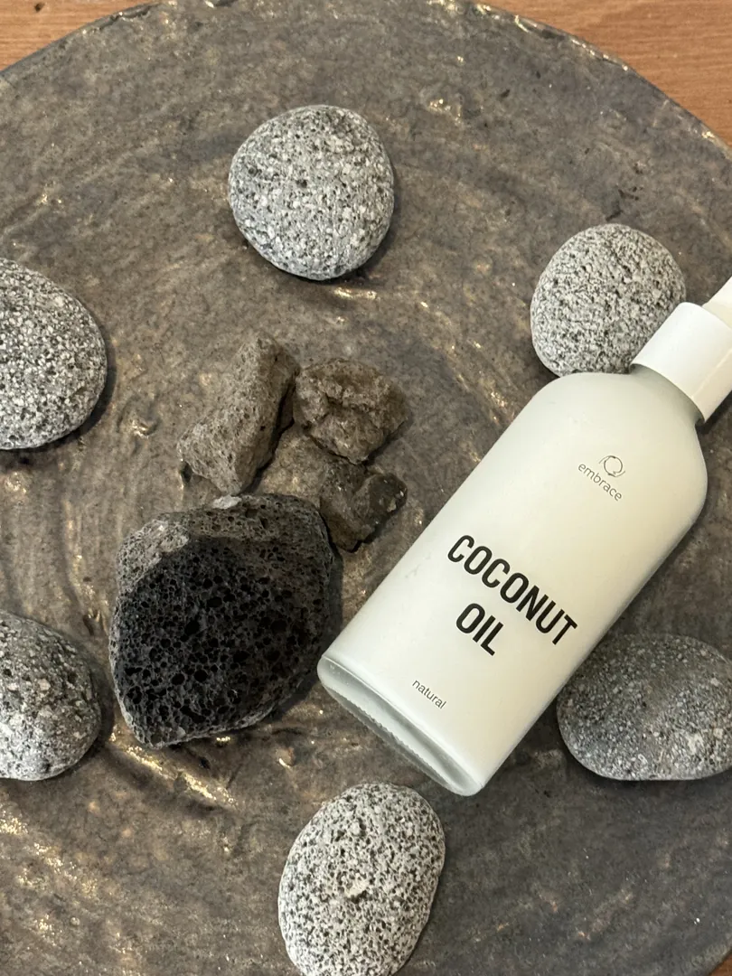 Coconut oil lying on dark stones