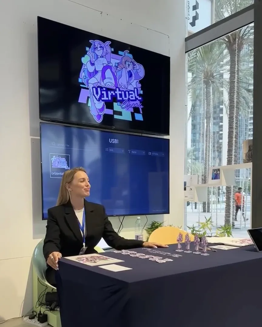 The GLITCH WORLD welcome desk under the exhibition screens