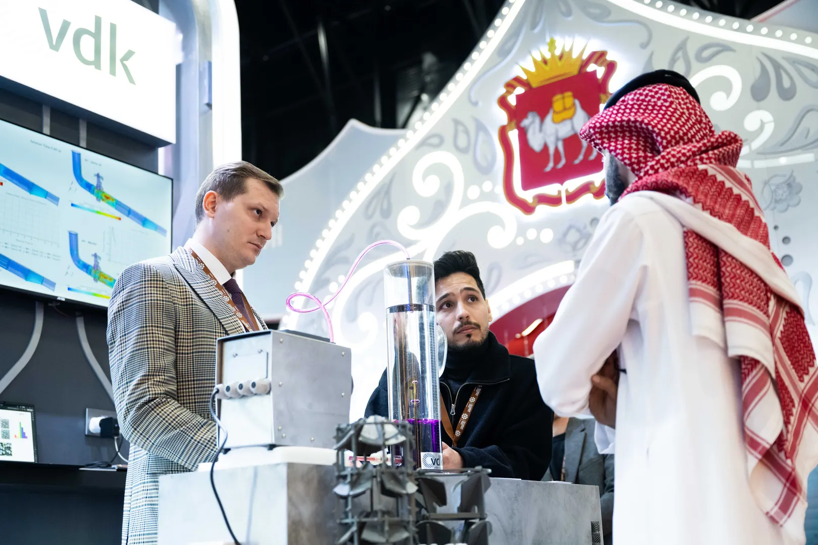 An exhibitor demonstrating equipment to visitors