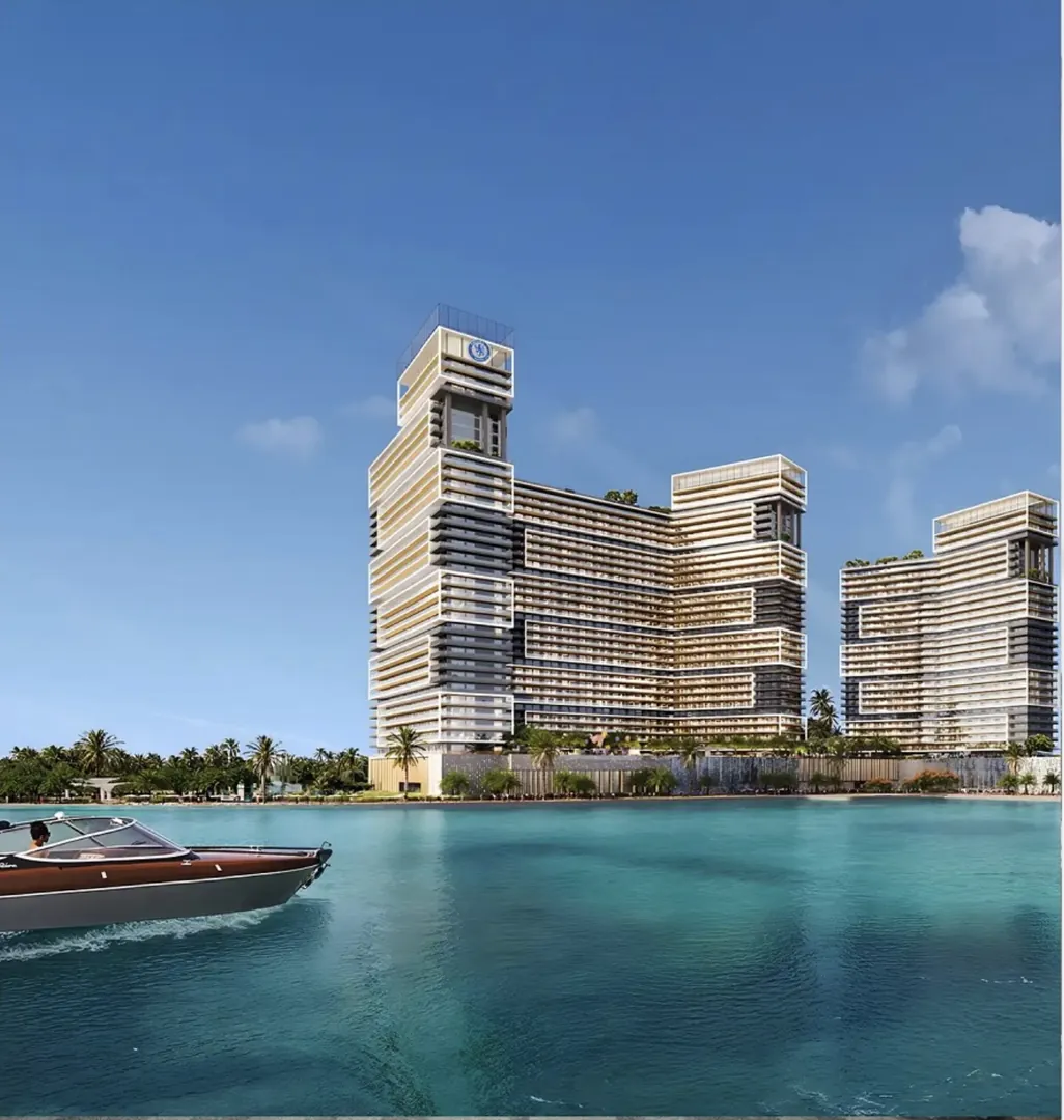 Towers on the waterfront with a boat passing