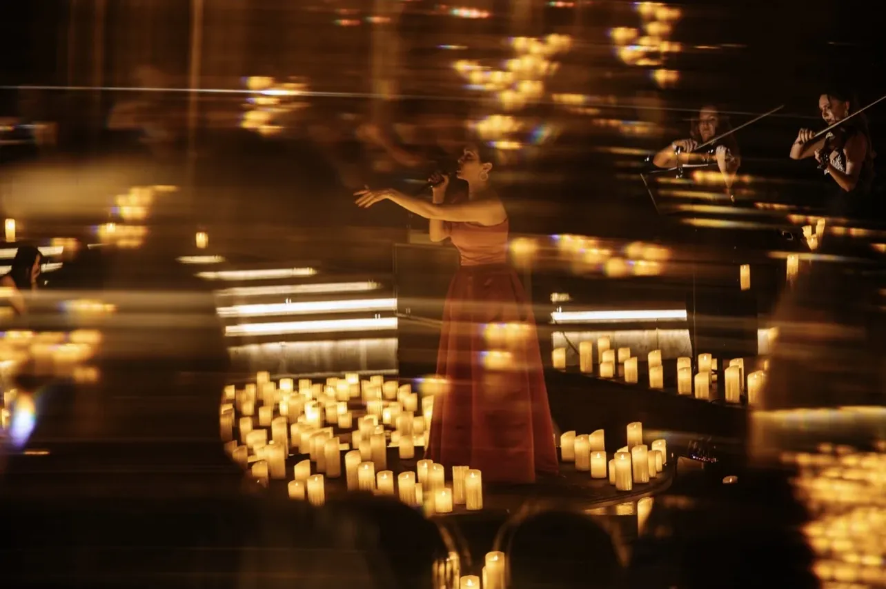 A soloist blurred in motion among the candlelight
