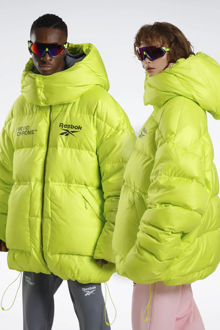 Two models in neon-green puffer jackets