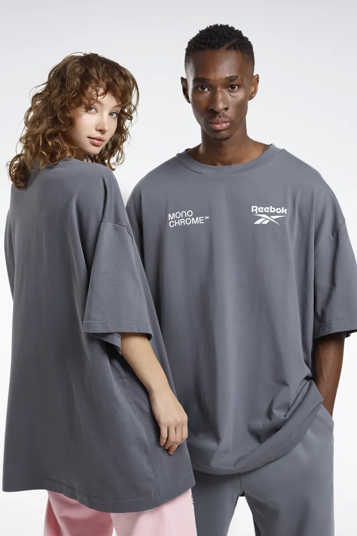 Two models in oversized grey tees from the collection