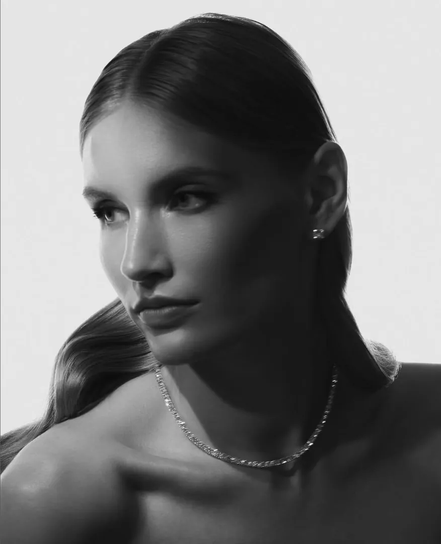 A black-and-white portrait wearing a Niobim necklace