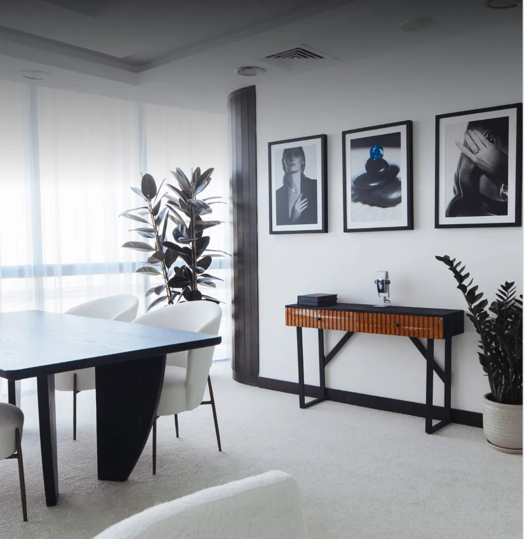 The atelier showroom with framed portraits on the wall