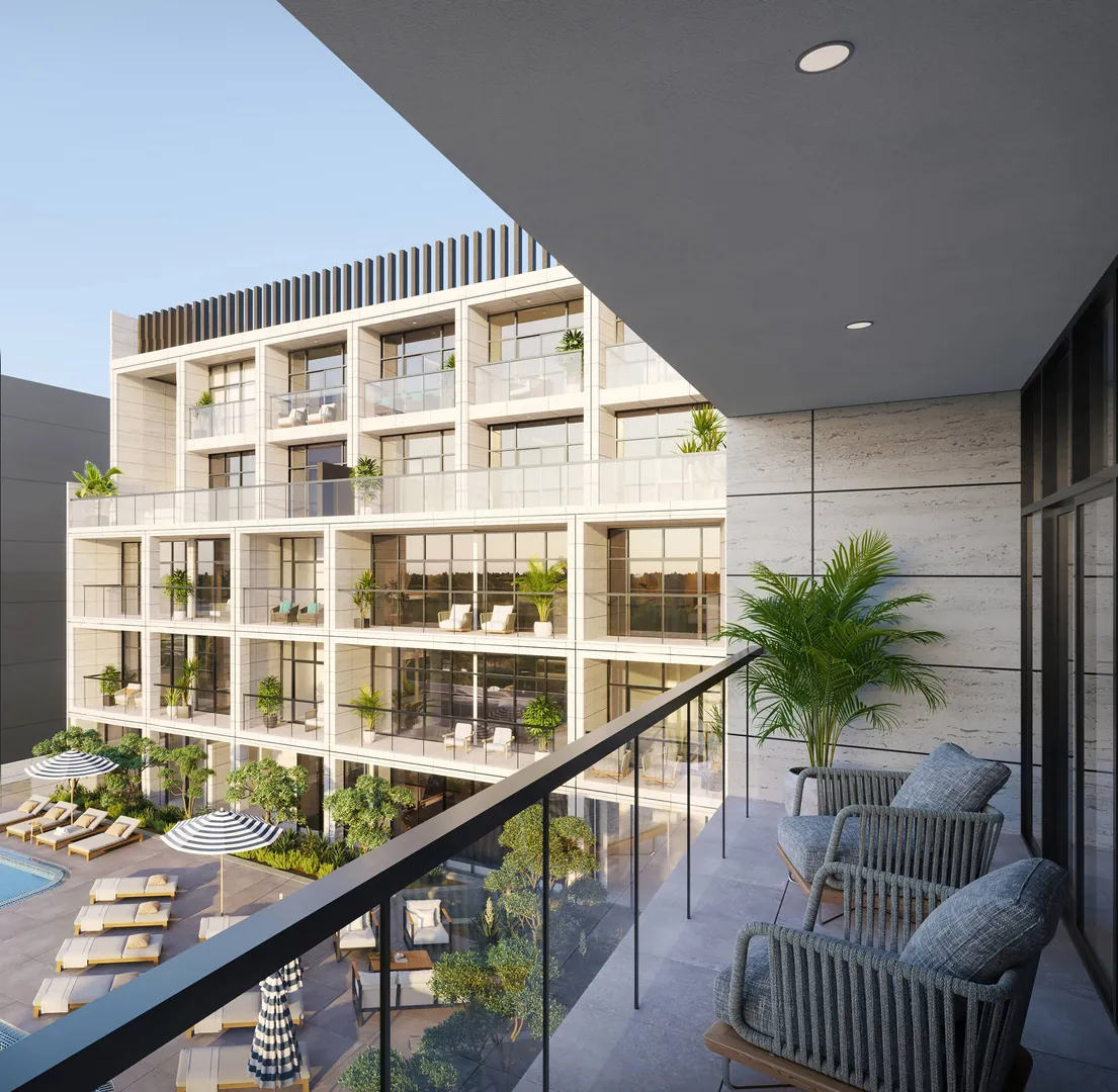 A balcony with lounge chairs over the courtyard